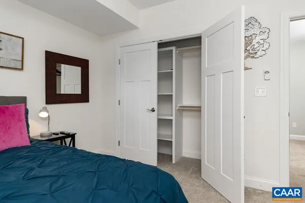 a view of big house with a big yard and large trees