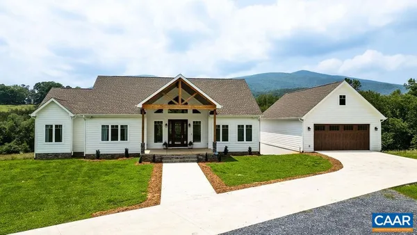 a view of house with yard outdoor seating area