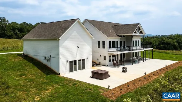 a living room with furniture and floor to ceiling windows