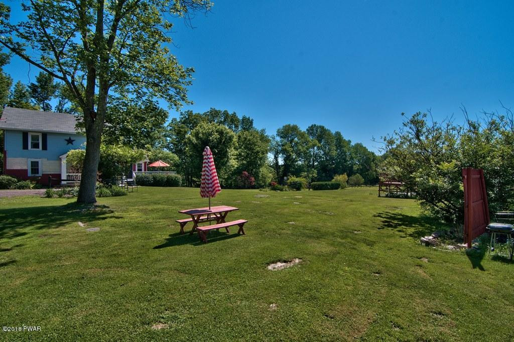 72 Hemlock Road Lake Ariel, PA 18436 - Photo 8 of 48 a big yard with swimming pool and green space
