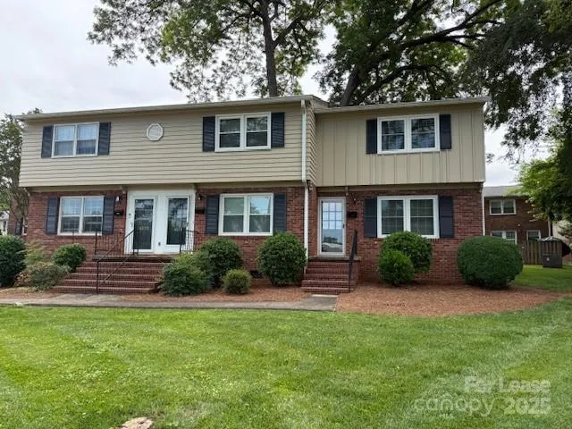 a view of a house with a yard and plants