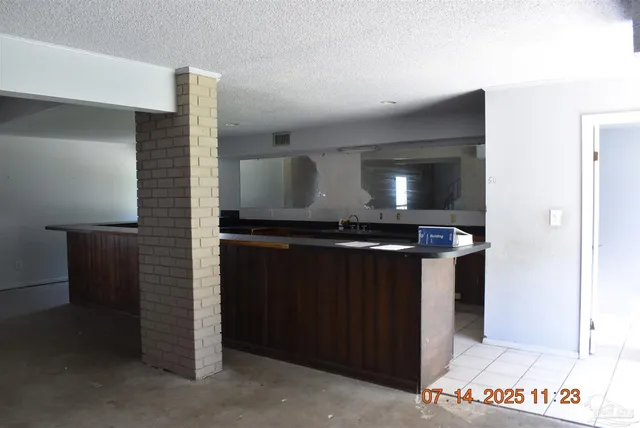 a kitchen with a refrigerator and a stove
