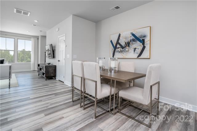 2061 Dornoch Road, Unit 1022B Tega Cay, SC 29708 - Photo 5 of 11 a view of a dining room with furniture window and wooden floor