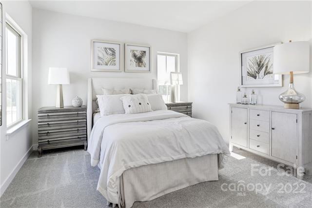 2061 Dornoch Road, Unit 1022B Tega Cay, SC 29708 - Photo 7 of 11 a bedroom with a bed and a night stand