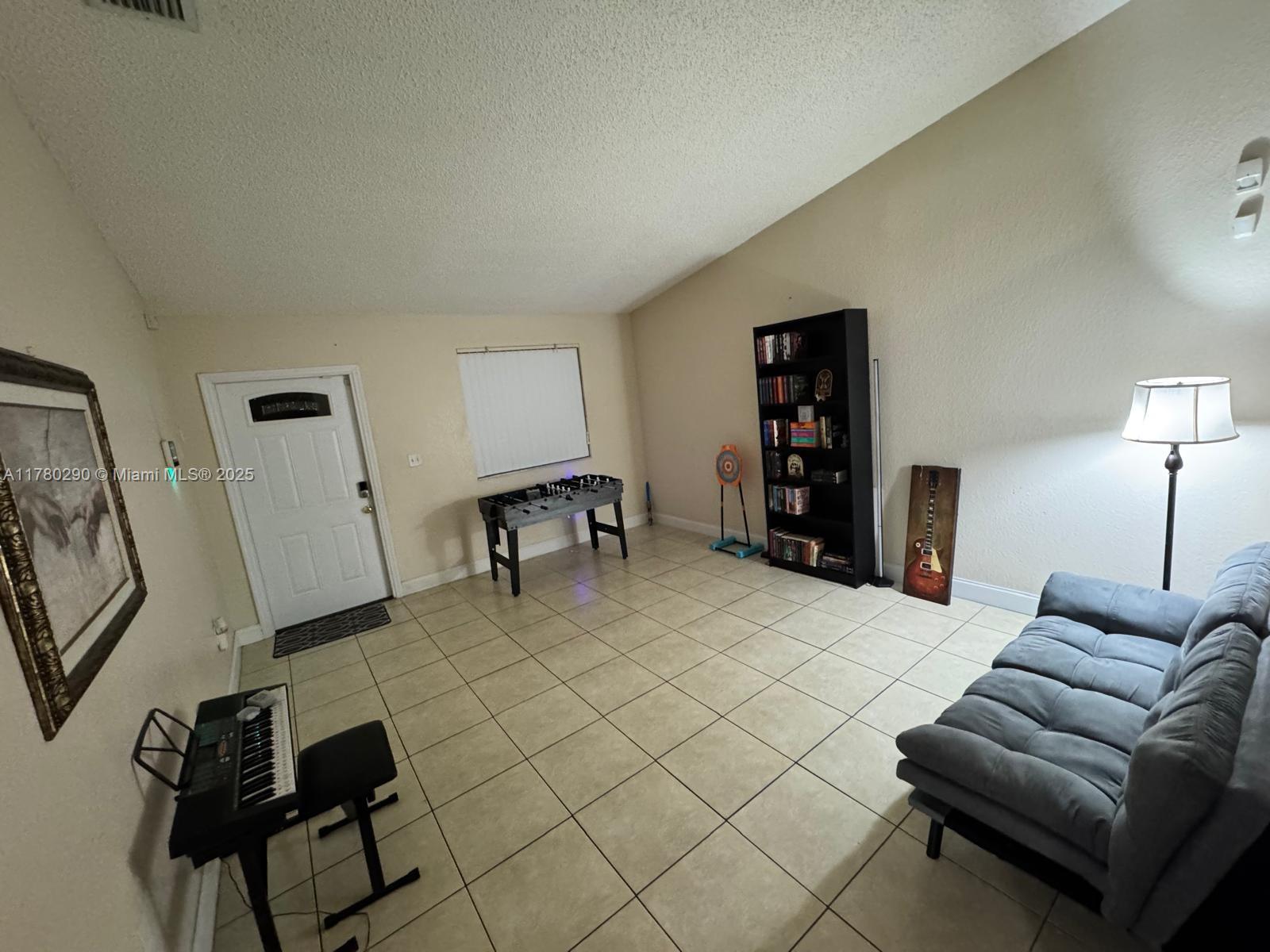Richmond Heights Miami, FL 33176 - Photo 5 of 7 a living room with furniture and a flat screen tv