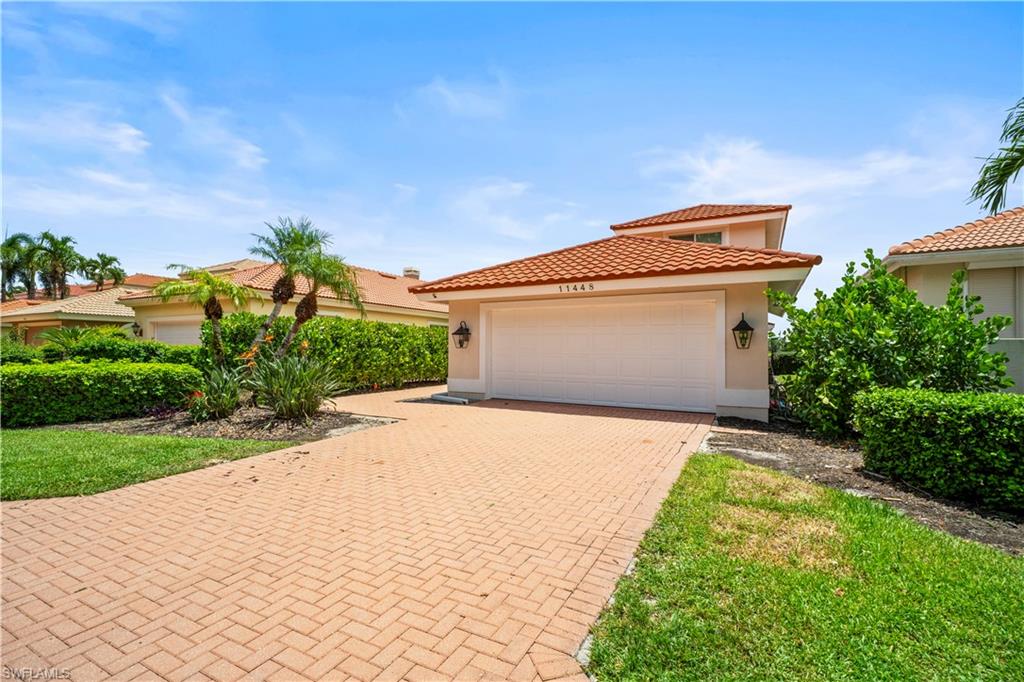 a front view of a house with a yard and garage
