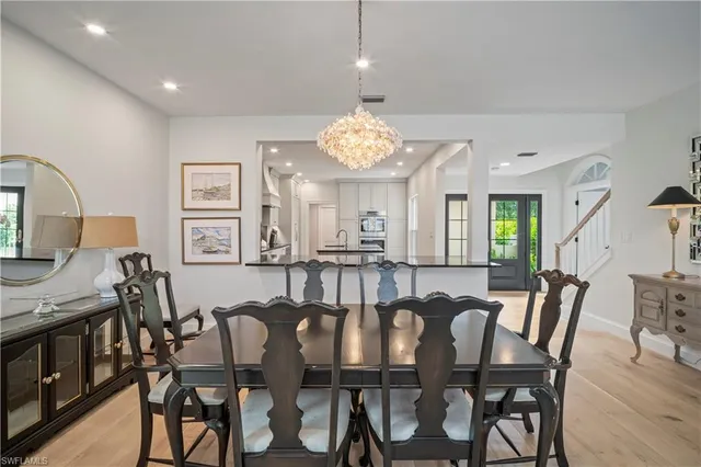 a view of a dining room with furniture and a chandelier