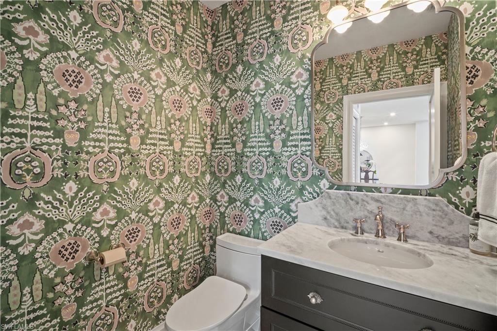 11448 Quail Village Way Naples, FL 34119 - Photo 15 of 41 a bathroom with a granite countertop toilet sink and mirror