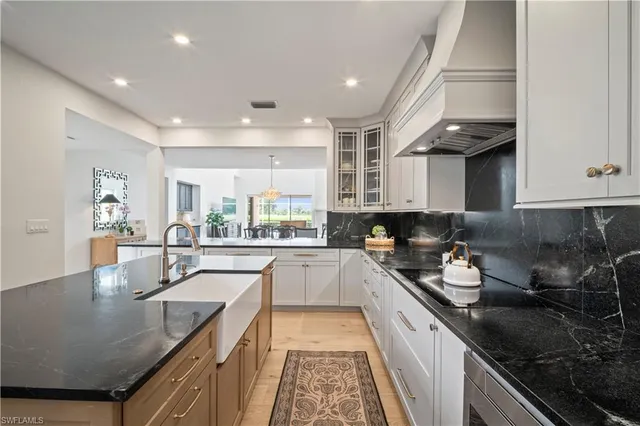 a kitchen with a sink stove and cabinets