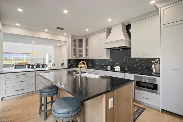 a kitchen with a stove sink and cabinets