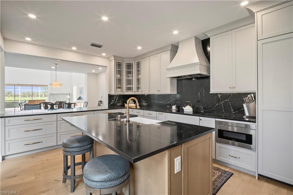 11448 Quail Village Way Naples, FL 34119 - Photo 18 of 41 a kitchen with a stove sink and cabinets