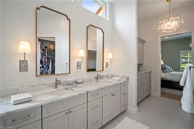 a en suite bathroom with a double vanity sink and a mirror