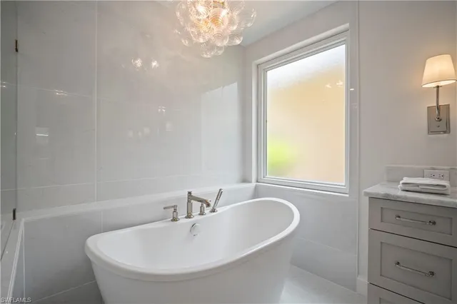 a bathroom with a bathtub and a sink