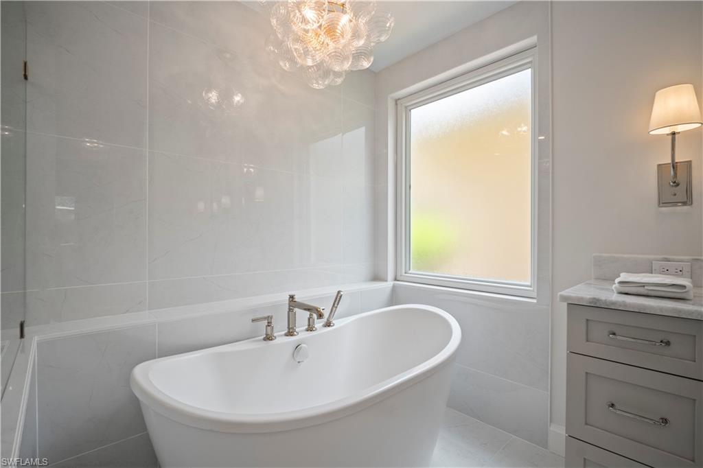 11448 Quail Village Way Naples, FL 34119 - Photo 25 of 41 a bathroom with a bathtub and a sink