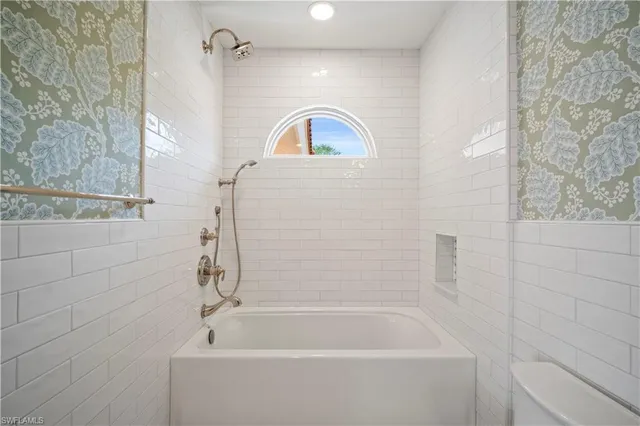 a bathroom with a sink a bathtub and shower