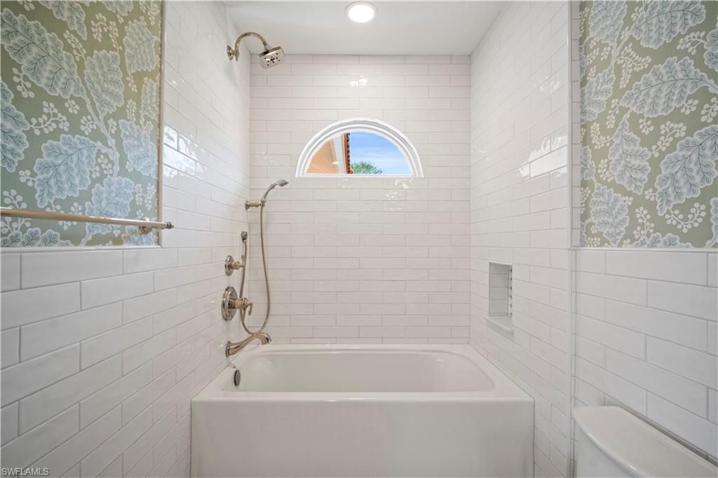 11448 Quail Village Way Naples, FL 34119 - Photo 32 of 41 a bathroom with a sink a bathtub and shower