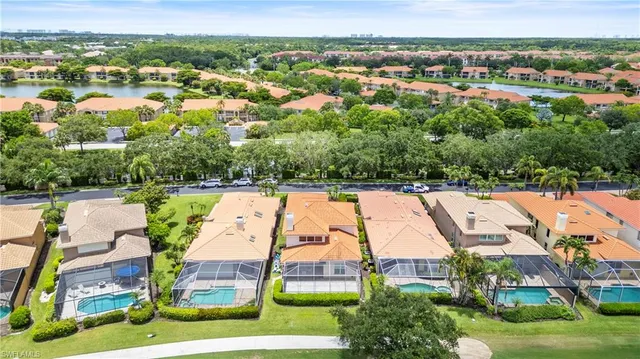 an aerial view of residential houses with outdoor space and swimming pool