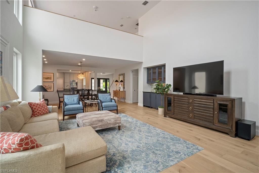 11448 Quail Village Way Naples, FL 34119 - Photo 7 of 41 a living room with furniture and a flat screen tv