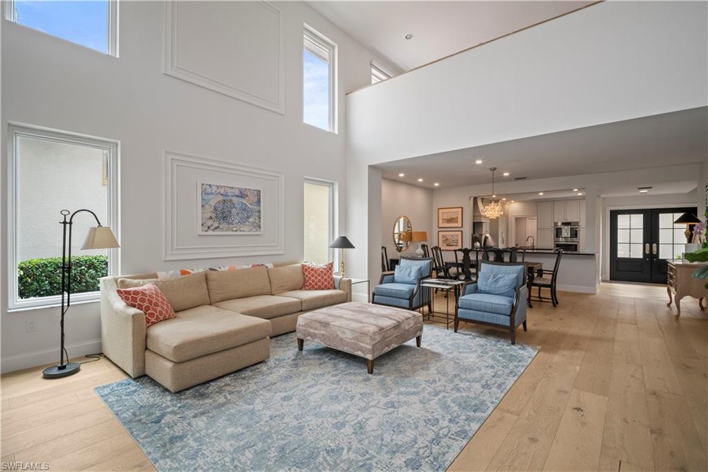 11448 Quail Village Way Naples, FL 34119 - Photo 8 of 41 a living room with furniture and wooden floor