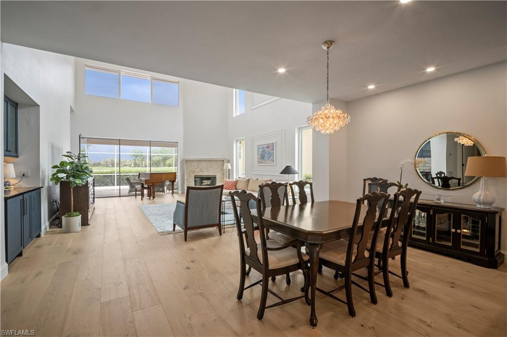 11448 Quail Village Way Naples, FL 34119 - Photo 10 of 41 a dining room with furniture and wooden floor