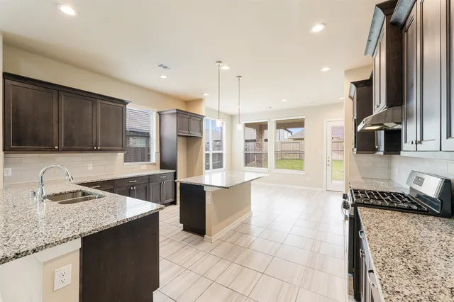 a living room with furniture a flat screen tv and a window