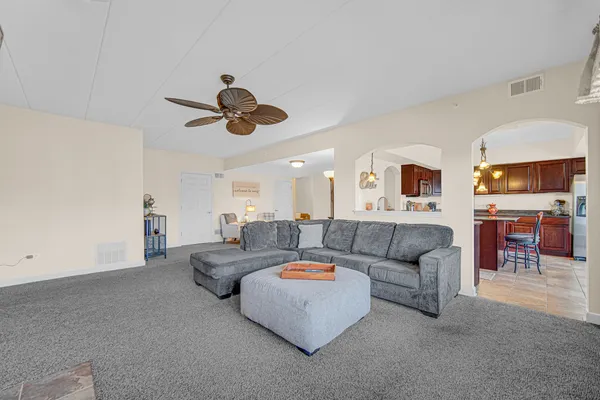 a living room with furniture and a chandelier