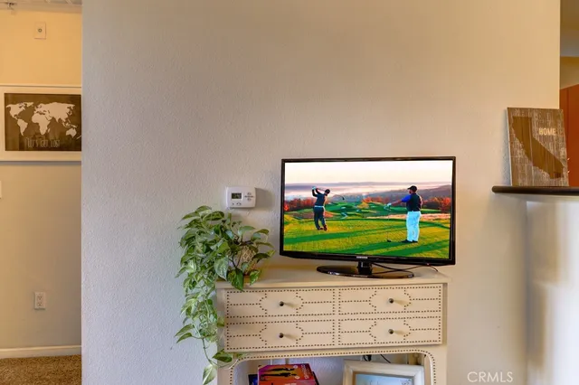 a living room with fireplace and flat screen tv