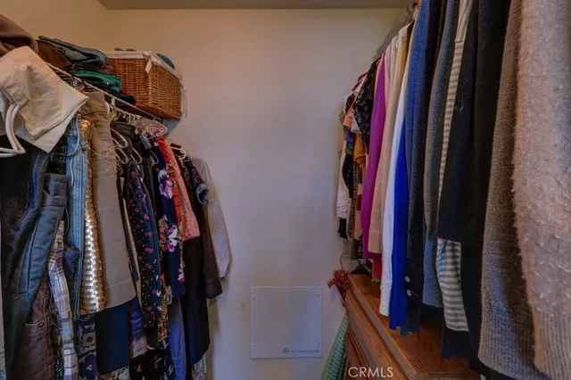 a view of walk in closet with clothes