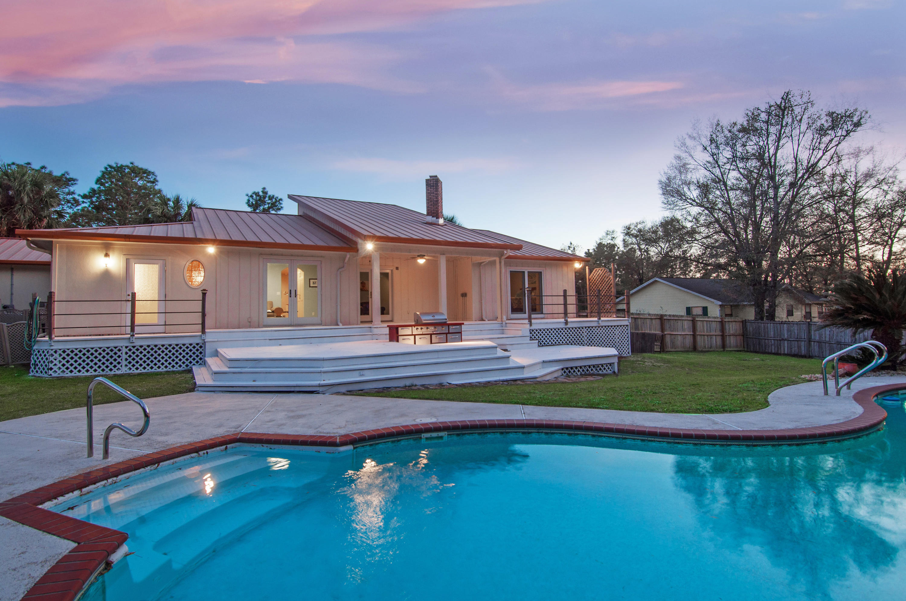 a front view of a house with swimming pool having outdoor seating