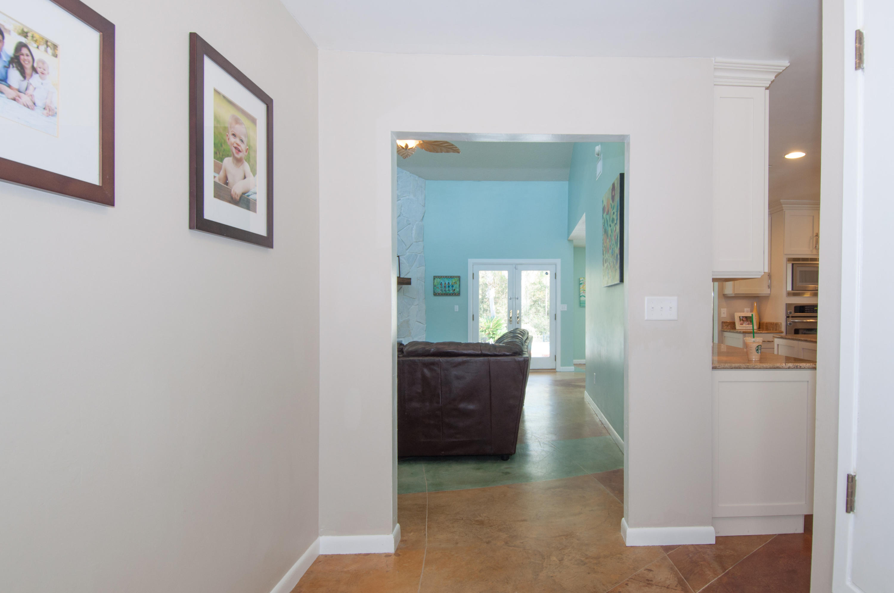 255 Ridge Lake Road Crestview, FL 32536 - Photo 12 of 54 a view of a hallway view with wooden floor and living room