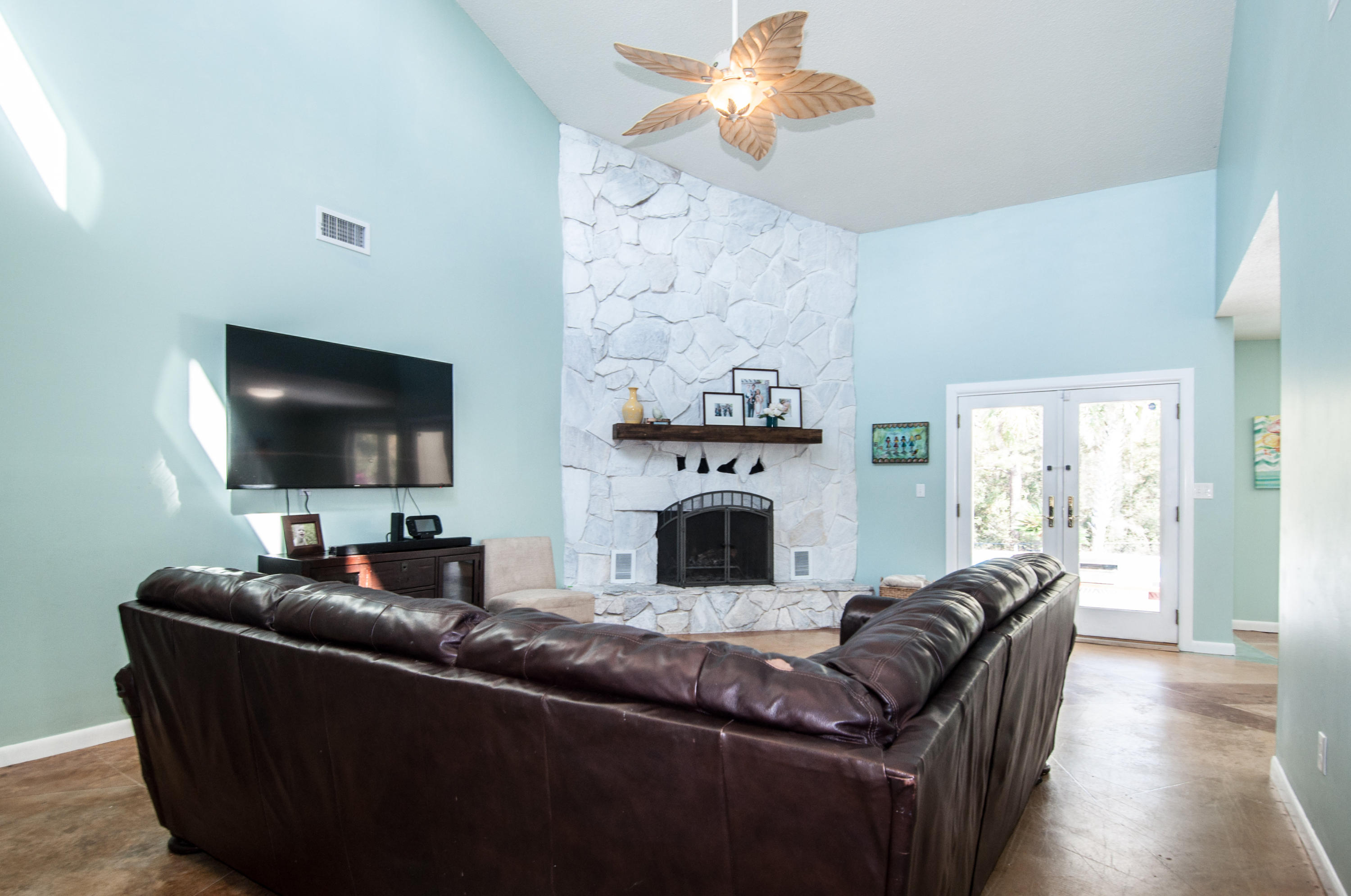 255 Ridge Lake Road Crestview, FL 32536 - Photo 13 of 54 a living room with furniture a flat screen tv and a fireplace