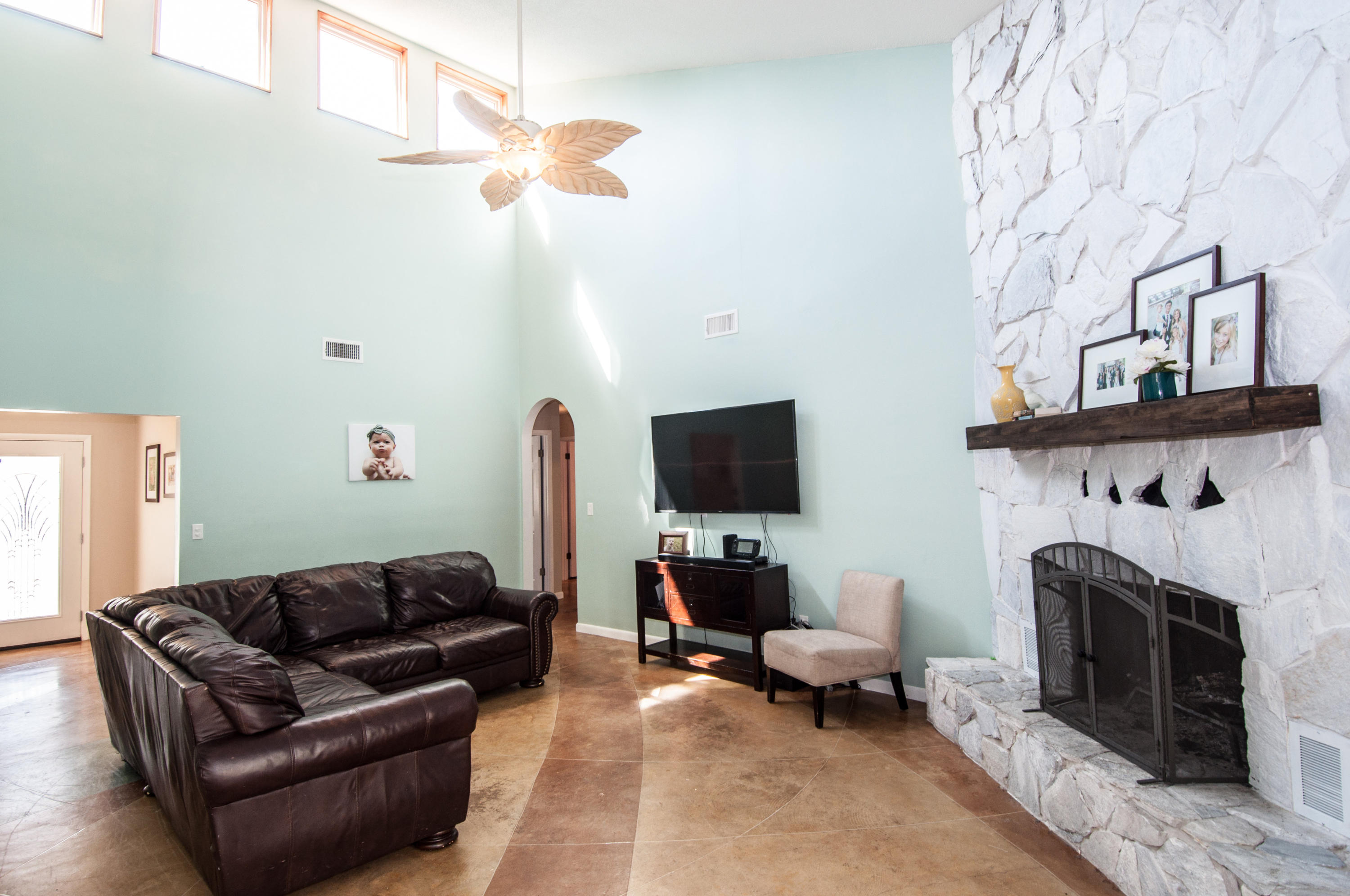 255 Ridge Lake Road Crestview, FL 32536 - Photo 15 of 54 a living room with furniture a fireplace and a flat screen tv