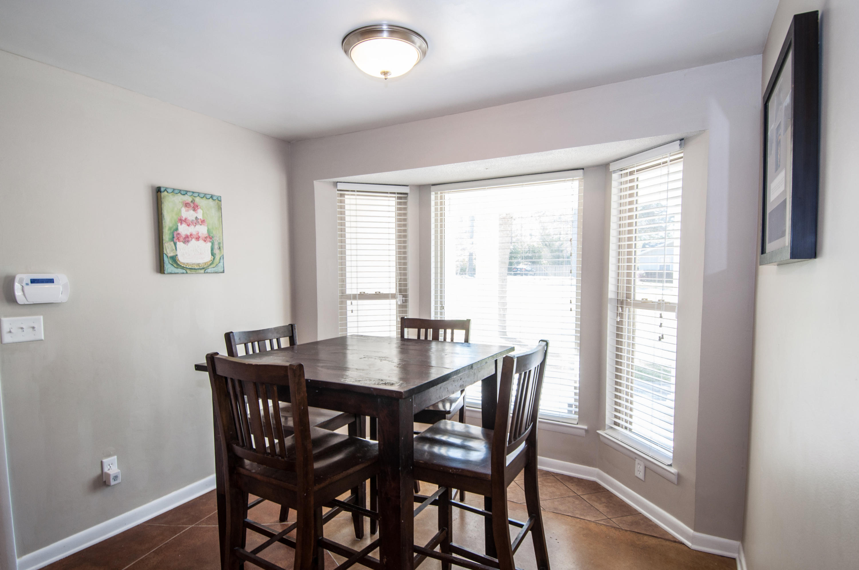 255 Ridge Lake Road Crestview, FL 32536 - Photo 22 of 54 a view of a dining room with furniture and wooden floor