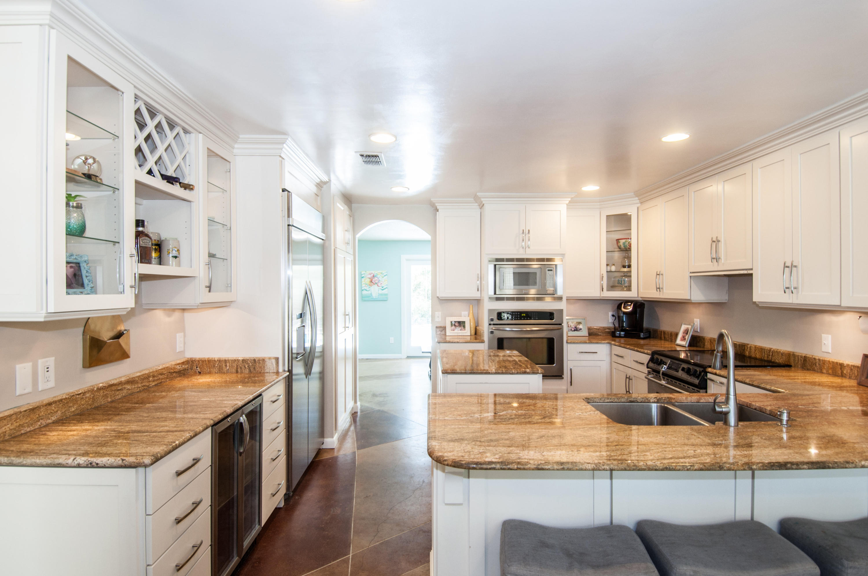 255 Ridge Lake Road Crestview, FL 32536 - Photo 25 of 54 a kitchen with stainless steel appliances granite countertop a stove top oven a sink a dining table and chairs