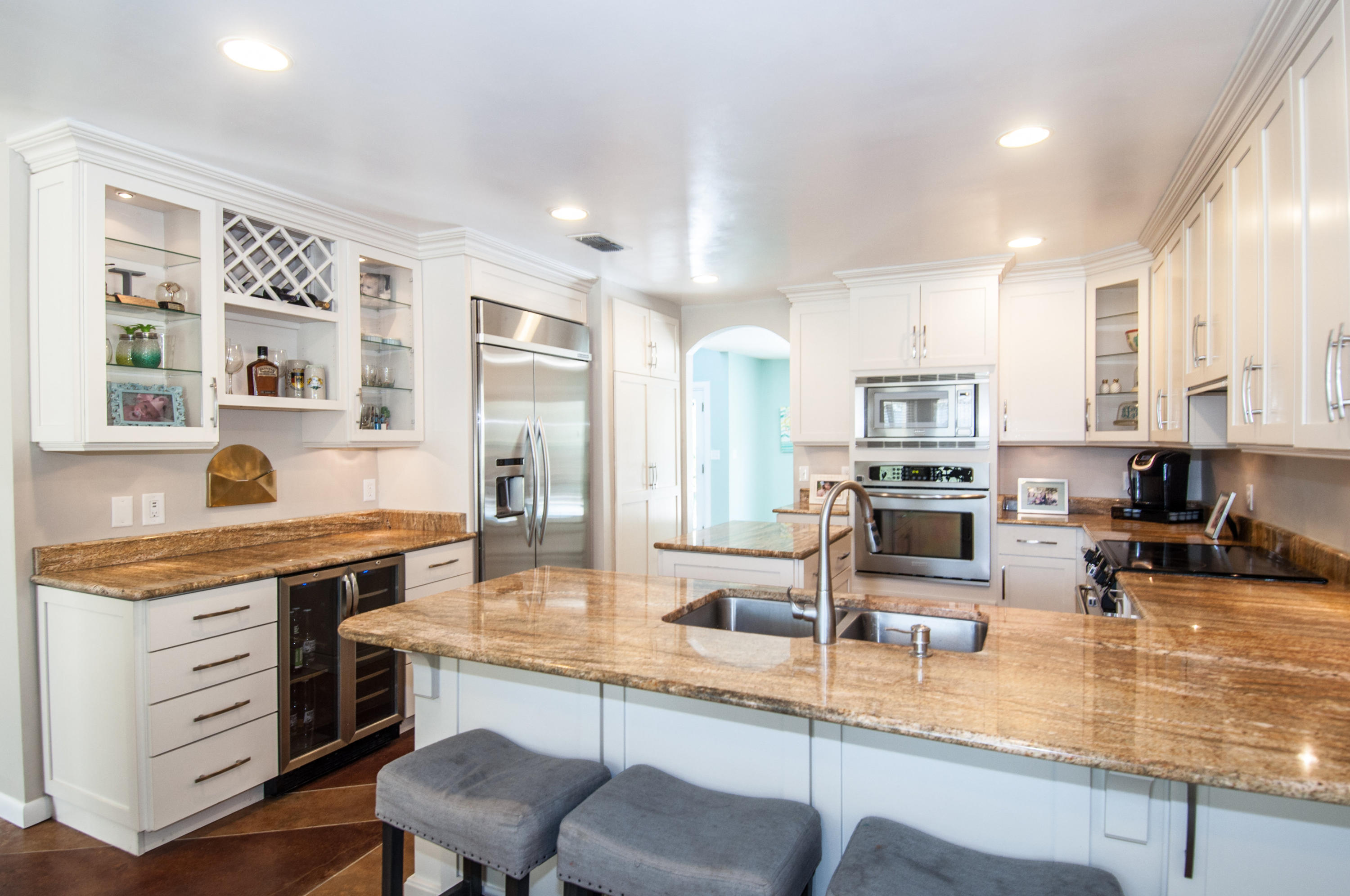 255 Ridge Lake Road Crestview, FL 32536 - Photo 26 of 54 a kitchen with stainless steel appliances granite countertop a stove top oven a sink dishwasher a dining table and chairs with wooden floor