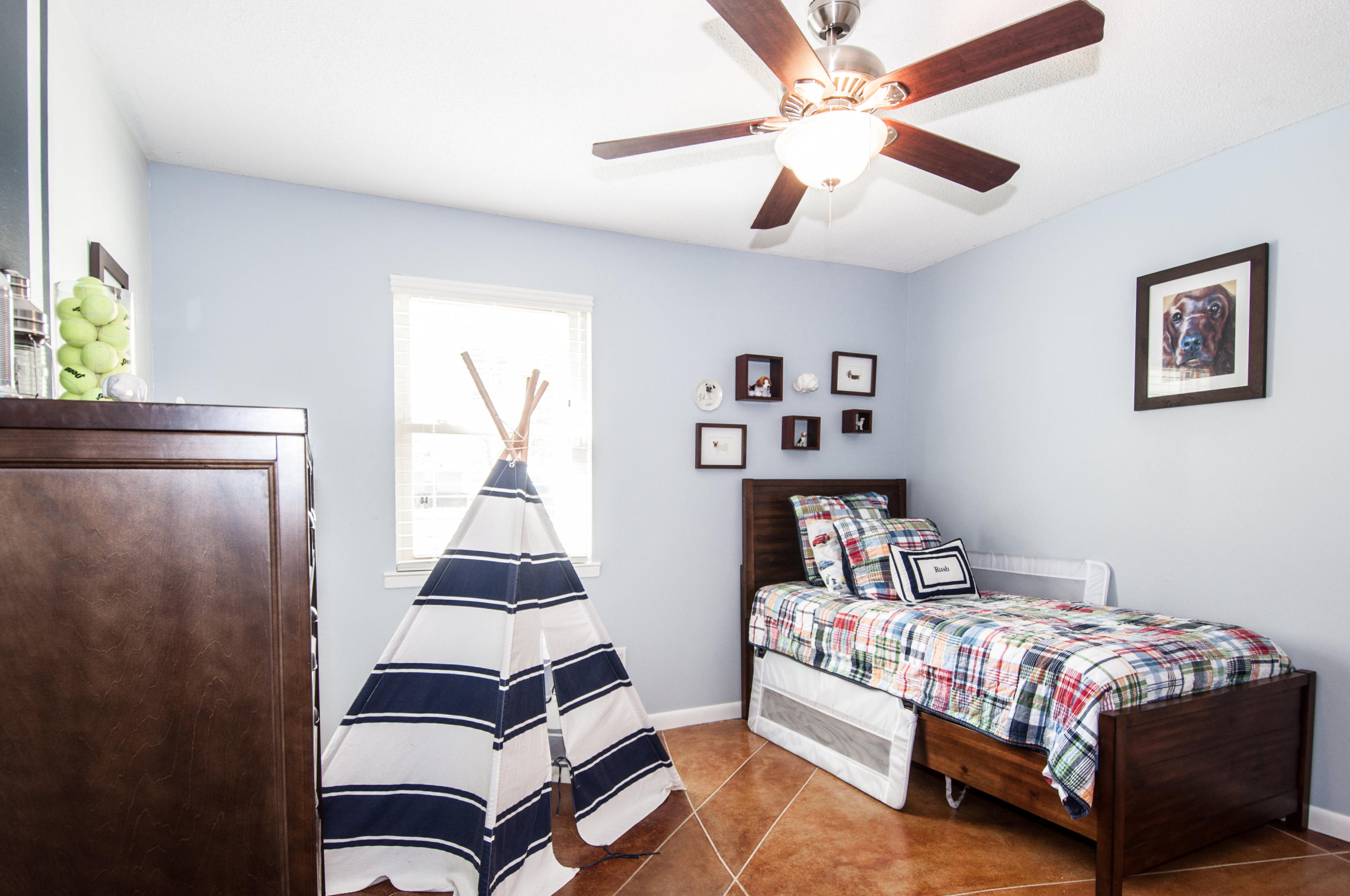 255 Ridge Lake Road Crestview, FL 32536 - Photo 31 of 54 a bedroom with a bed and wooden floor