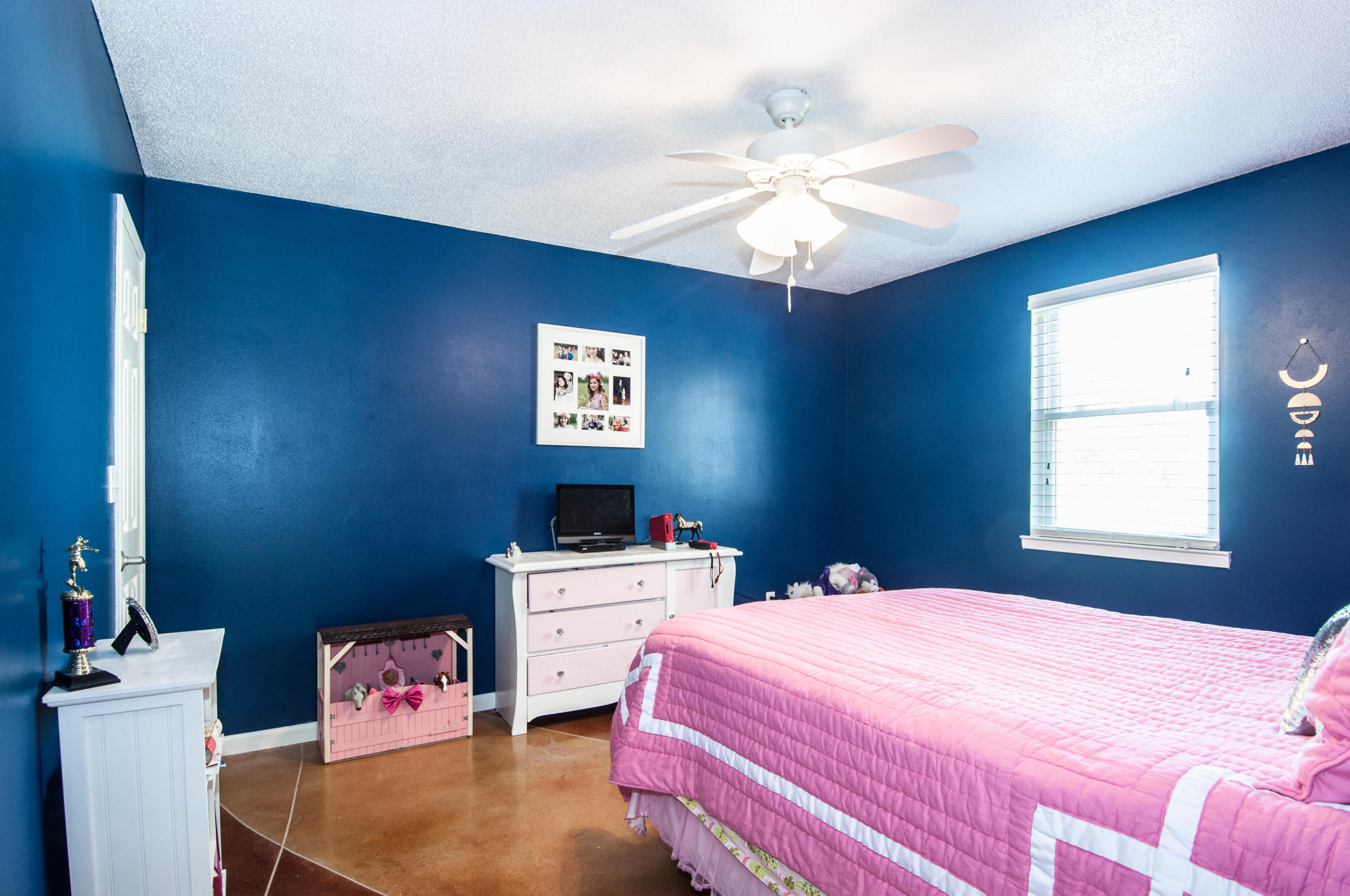 255 Ridge Lake Road Crestview, FL 32536 - Photo 35 of 54 a bedroom with a bed and a chandelier