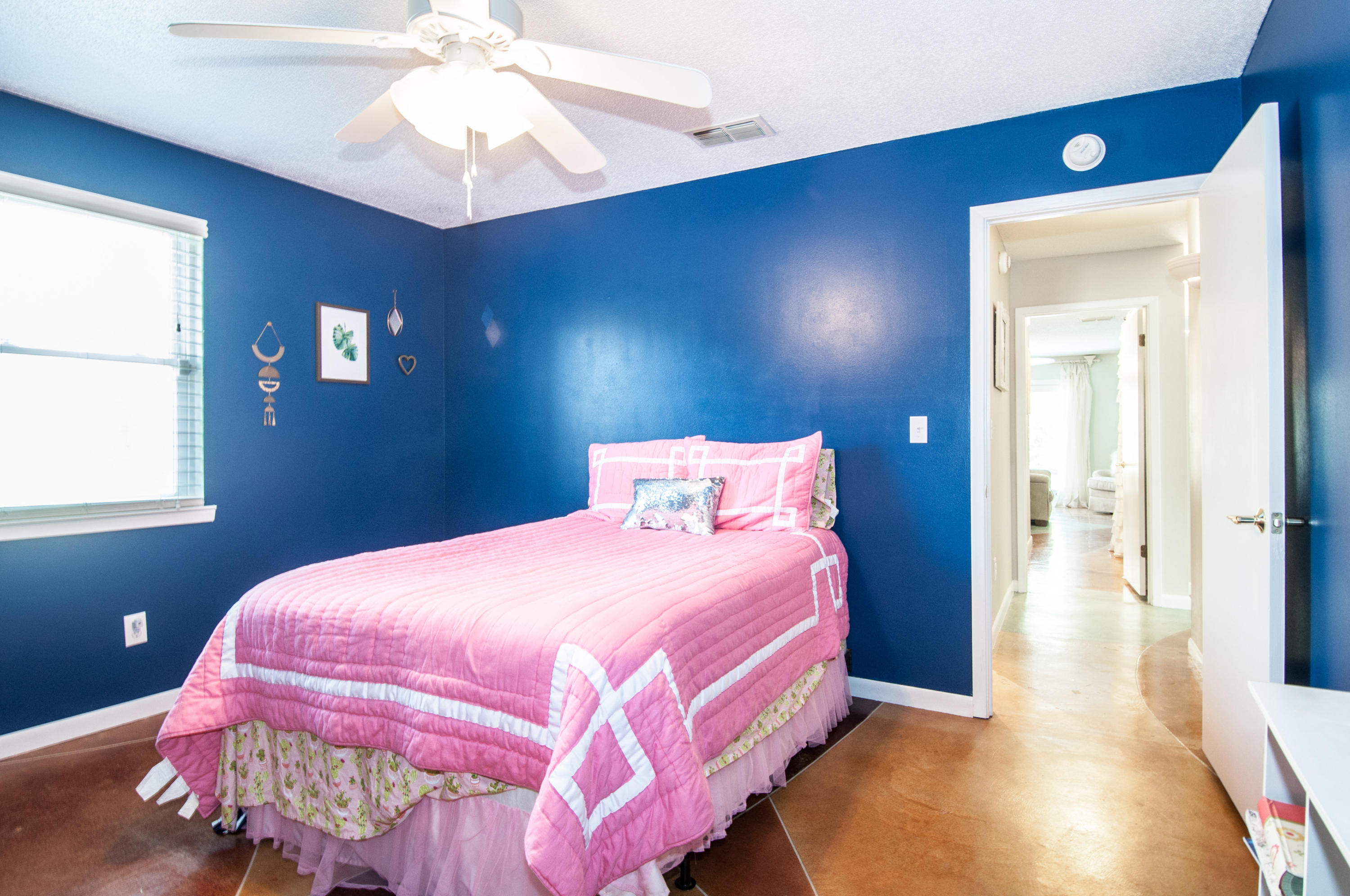 255 Ridge Lake Road Crestview, FL 32536 - Photo 36 of 54 a bedroom with a bed and a chandelier