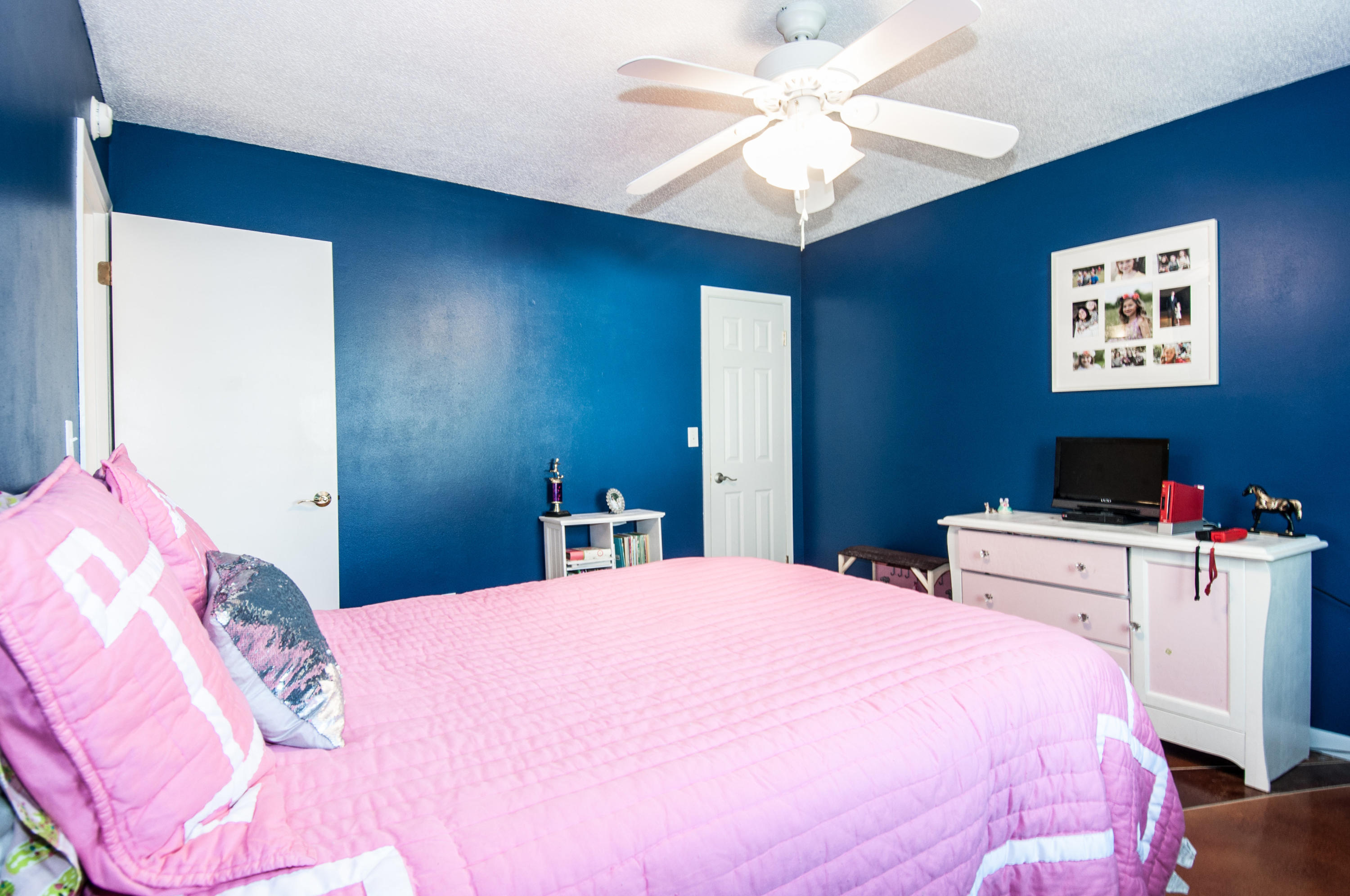 255 Ridge Lake Road Crestview, FL 32536 - Photo 37 of 54 a bedroom with a bed and a chandelier