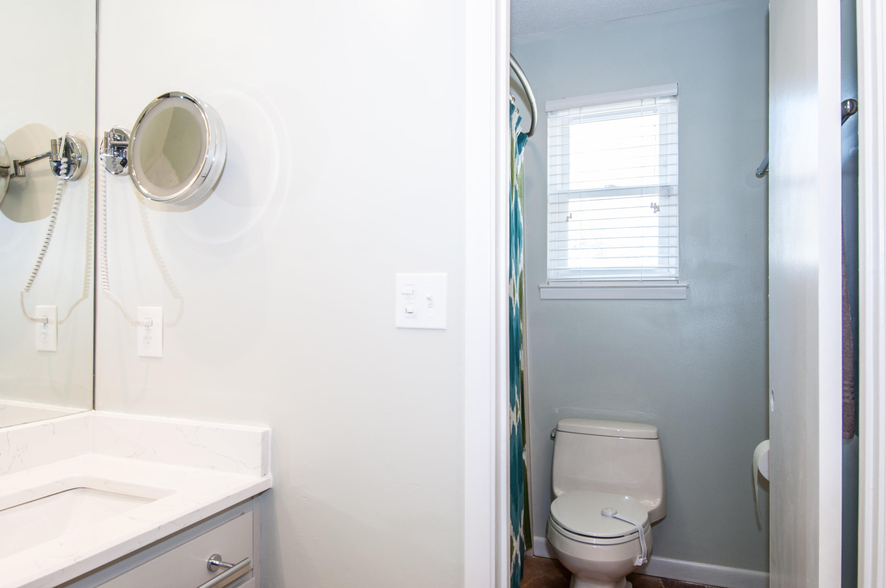 255 Ridge Lake Road Crestview, FL 32536 - Photo 40 of 54 a bathroom with a granite countertop toilet a sink and a mirror
