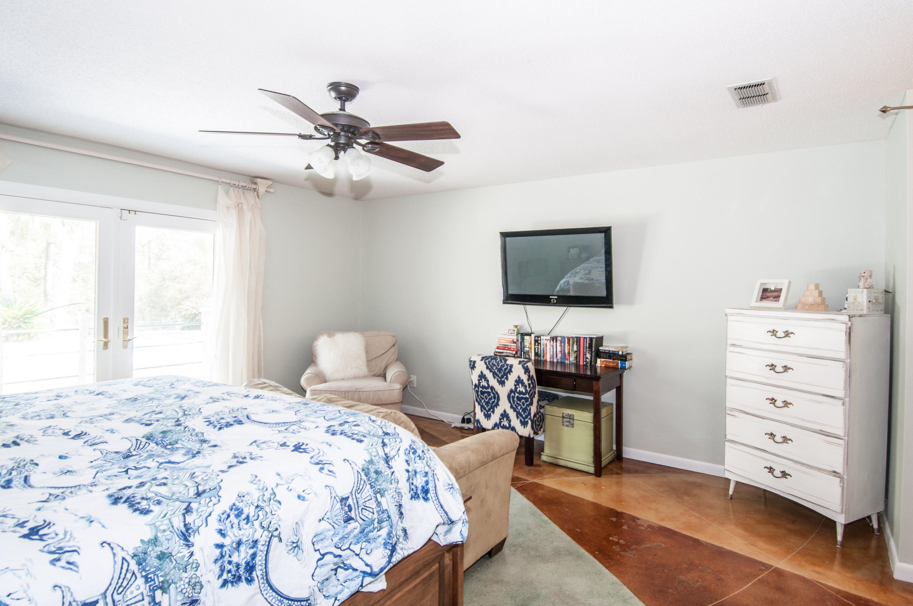 255 Ridge Lake Road Crestview, FL 32536 - Photo 48 of 54 a bedroom with a bed and a flat tv screen on dresser