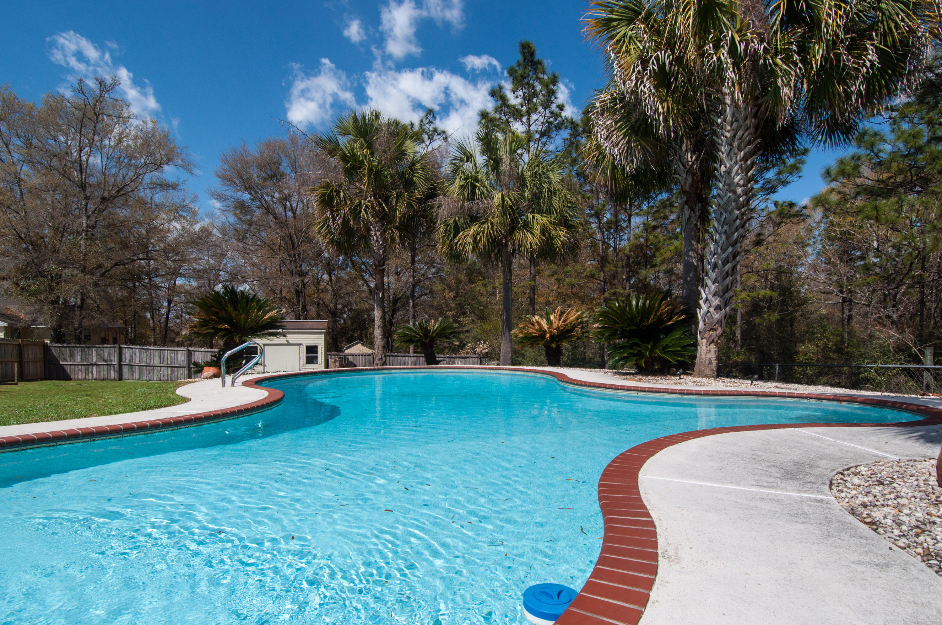 255 Ridge Lake Road Crestview, FL 32536 - Photo 8 of 54 a view of a swimming pool with an outdoor space and seating area