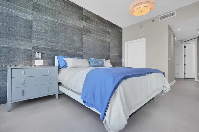 a bedroom with a bed and a wall painting