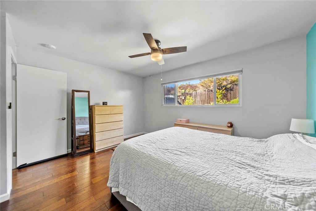 10634 Sanfred Court Santee, CA 92071 - Photo 18 of 44 a bedroom with a bed and a chandelier