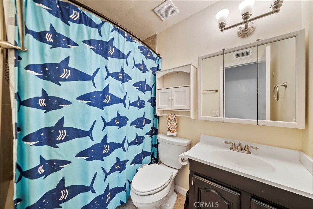 10634 Sanfred Court Santee, CA 92071 - Photo 21 of 44 a bathroom with a sink mirror vanity and toilet