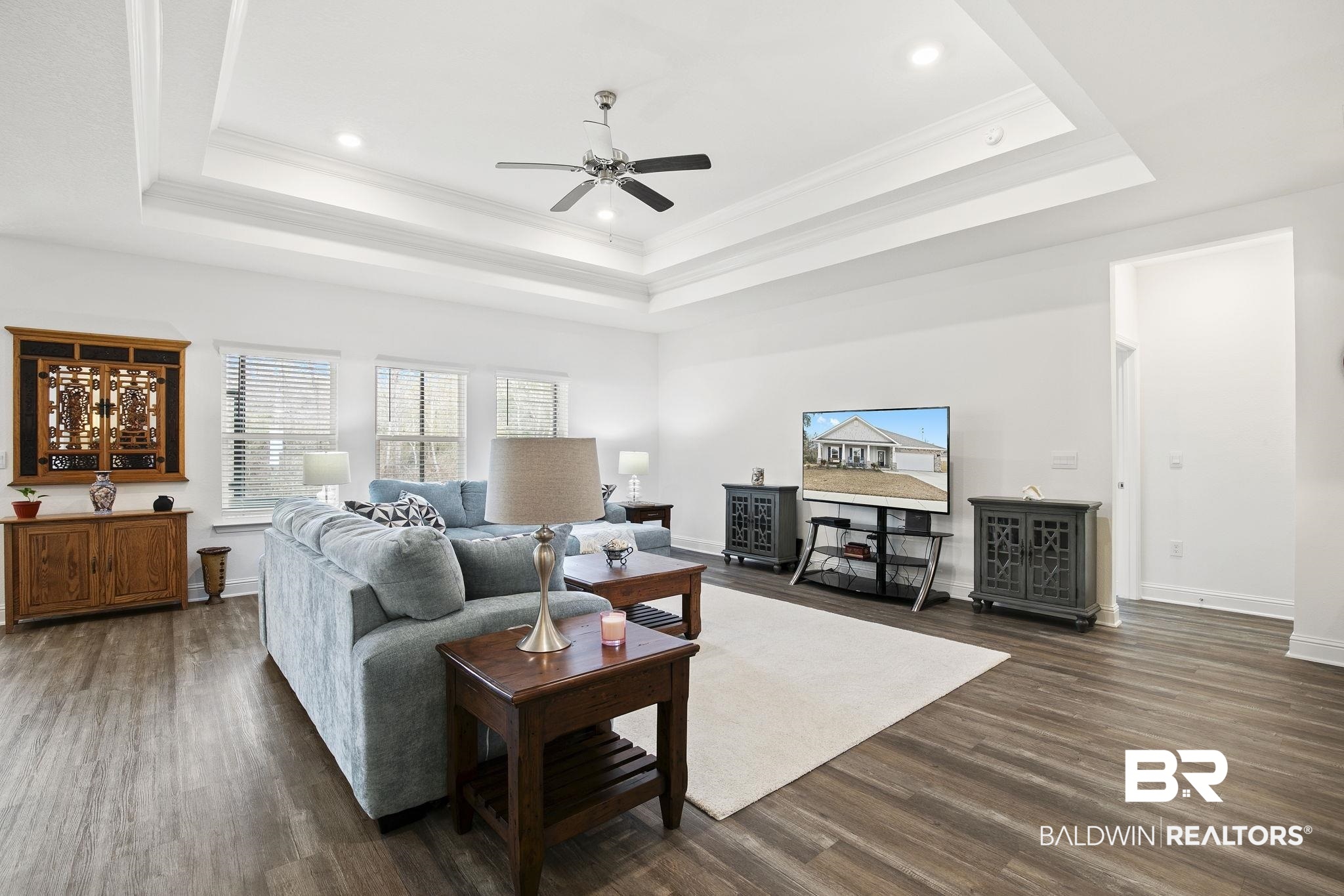 1141 Pencarro Boulevard Foley, AL 36535 - Photo 13 of 70 Living room featuring dark hardwood / wood-style flooring, ornamental molding, a raised ceiling, and ceiling fan