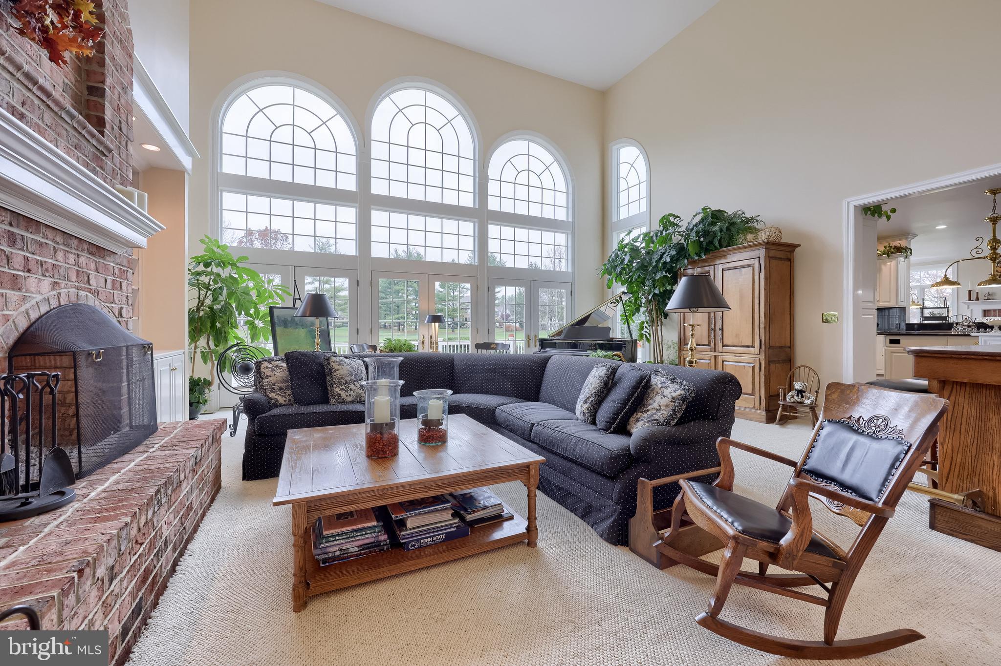 78 Oakhill Drive Lititz, PA 17543 - Photo 32 of 90 a living room with furniture a chandelier a large window and potted plants