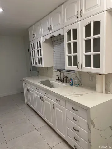 a kitchen with stainless steel appliances granite countertop a sink dishwasher stove and cabinets