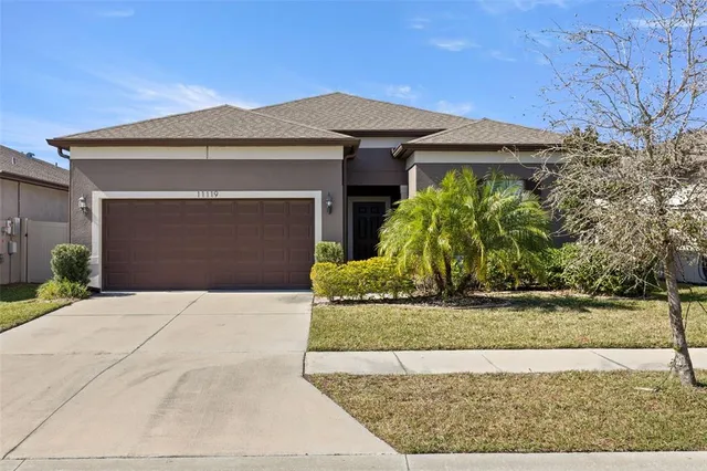 a front view of a house with a yard and garage