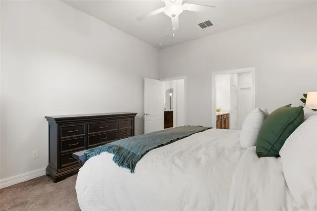 a bedroom with a bed and a dresser